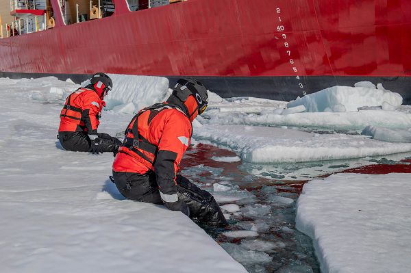 U.S. Coast Guard Petty Officer 1st Class Joshua Tangermann and Petty Officer 2nd Class Harrison Bauer, boatswain’s mates, lower themselves into the water while practicing ice rescue techniques in McMurdo Sound, Antarctica, Dec. 29, 2023. Operation Deep Freeze is one of many operations in the Indo-Pacific in which the U.S. military promotes security and stability across the region. (U.S. Coast Guard photo by Petty Officer 3rd Class Ryan Graves)