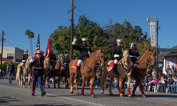 U.S. Marine Corps' Mounted Color Guard carries the American Flag and the Marine Corps Standard in the 135th Rose Parade in Pasadena, Calif., on Jan. 1, 2024. The Rose Parade is part of an annual celebration, Tournament of Roses, that includes various floats, bands, dancers and equestrian units, and is meant to showcase the beauty of Pasadena, Calif. (U.S. Marine Corps photo by Cpl. Kristina Judy)
