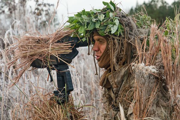 U.S. Marine Corps Cpl. Sean Hall, a student with the Scout Sniper Course, School of Infantry-East, conducts reconnaissance during a training event at Marine Corps Base Camp Lejeune, North Carolina, Dec. 13, 2023. This course marks the last iteration of the Scout Sniper Course at the School of Infantry-East, which has trained Marines and other service members in long-range precision fires and field craft necessary to provide reconnaissance and surveillance in support of combat operations. (U.S. Marine Corps photo by Lance Cpl. Zachary Candiani)