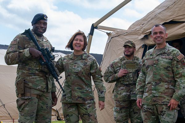 From left: U.S. Air Force Tech. Sgt. Jaboree Kiel, an 137th Special Operations Wing Mission Sustainment Team trainer, Oklahoma Air National Guard, Chief Master Sgt. of the Air Force JoAnne S. Bass, Staff Sgt. Tyrone Harrison, a civil engineer Airman with the 137th SOW MST, and Chief Master Sgt. John Alsvig, Air Force first sergeant special duty manager, share a laugh as a well-camouflaged Airman rises from the landscape during a visit to the 137th SOW, Will Rogers Air National Guard Base, Oklahoma City, Oct. 12, 2023. Citizen Airmen with the 137th SOW demonstrated how they bring their multi-capable skill sets to the total force fight and use customized resources for optimum performance against global power competition. (U.S. Air National Guard photo by Airman 1st Class Erika Chapa)