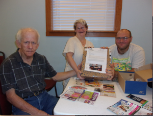 Adults at Building Blocks Ministries cut coupons. Photo courtesy of center support our troops special needs adults troopons