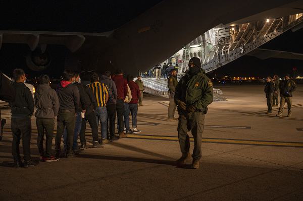 U.S. Customs and Border Protection Agents guide illegal aliens onboard a C-17 Globemaster III at the Tucson International Airport, Ariz., Jan. 23, 2025. Under the direction of U.S. Northern Command, U.S. Transportation Command is supporting Immigration and Customs Enforcement removal flights by providing military airlift. (Dept. of Defense photo by Senior Airman Devlin Bishop)
