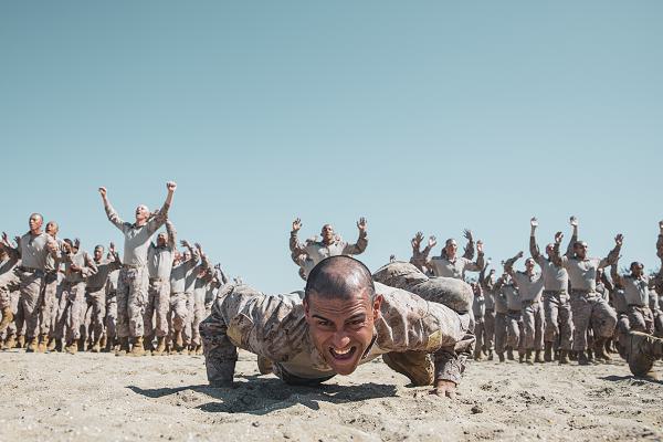 U.S. Marine Corps recruits with Hotel Company, 2nd Recruit Training Battalion, conduct dynamic warm-ups prior to a pugil sticks training event at Marine Corps Recruit Depot San Diego, California, Feb. 25, 2025. Recruits are taught Marine Corps Martial Arts Program techniques that instill basic self-defense that they will execute throughout recruit training during events like body sparring and pugil sticks to help build a warrior ethos and Esprit de Corps. (U.S. Marine Corps photo by Cpl. Sarah M. Grawcock)