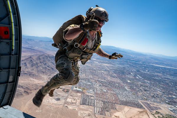 Master Sgt. Trevor Clark, 88th Test and Evaluation Squadron pararescueman, leaps from an HH-60W Jolly Green II during a combat arms demonstration at the 2025 Aviation Nation Air Show at Nellis Air Force Base, Nev., April 5, 2025. The CAD demonstrated dynamic displays of skill, tactics and small arms proficiency — educating, engaging and inspiring both Airmen and the public. (U.S. Air Force photo by Staff Sgt. Jose Miguel Tamondong) 