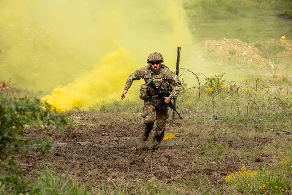 U.S. Army Spc. Samuel Roberts assigned to Bravo Company, 4th Battalion, 6th Infantry Regiment, 3rd Armored Brigade Combat Team, 1st Armored Division, heads to cover after planting a charge during a live fire exercise at Novo Selo Training Area, Bulgaria, May 12, 2025. Live fire exercises give Soldiers an immersive training experience that prepares them to defend against enemy threats in a dynamic and engaging operational environment. (U.S. Army photo by Spc. Nathan Arellano Tlaczani)