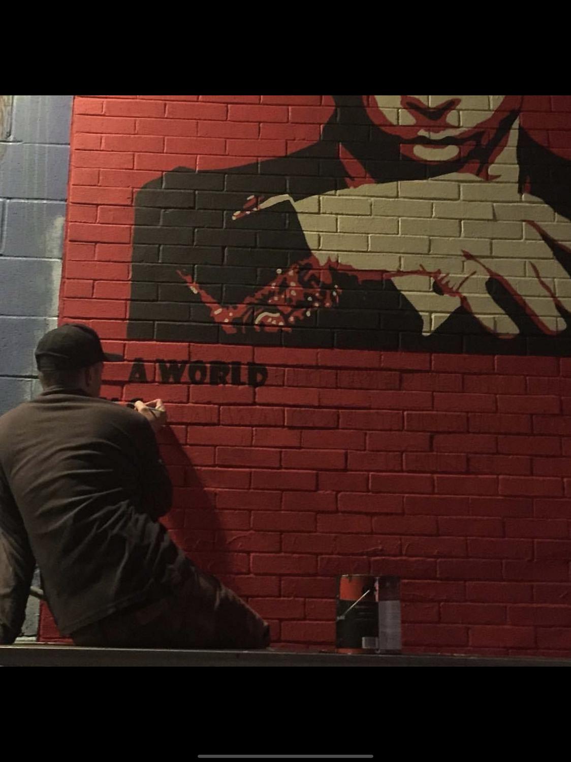 Jamie Pearson works on one of his murals.