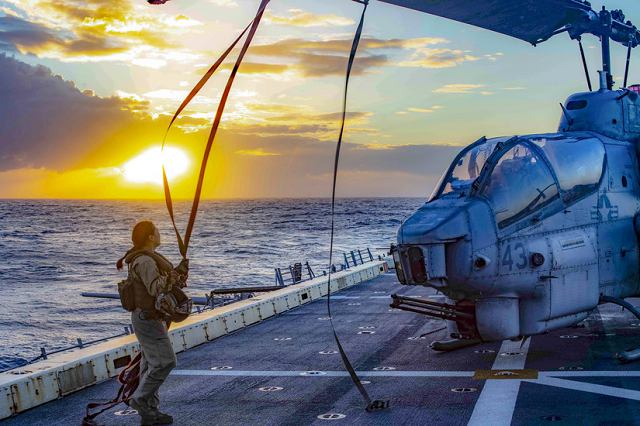 Marine Corps Capt. Brenda Amor helps to prepare an AH-1W Super Cobra helicopter for flight operations on the flight deck of the USS Arlington in the Mediterranean Sea, Jan. 30, 2019.