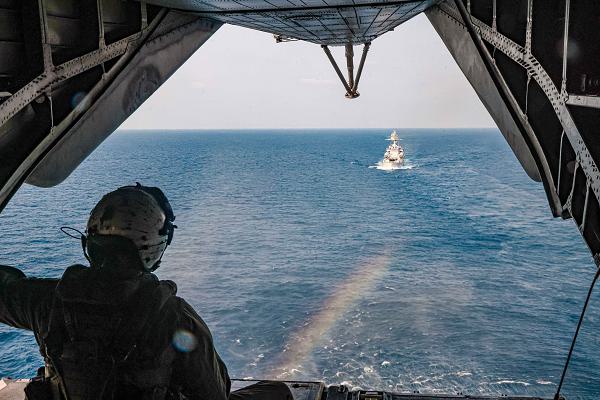 U.S. Marine Corps Cpl. Jacob Sellers, a crew chief assigned to Marine Medium Tiltrotor Squadron (VMM) 165 (Reinforced), 15th Marine Expeditionary Unit, monitors a CH-53E Super Stallion attached to VMM 165 (Rein.), 15th MEU, as it lifts off for a photo exercise during Exercise Tiger TRIUMPH in the Indian Ocean, March 26, 2024. Tiger TRIUMPH is a U.S.-India tri-service amphibious exercise focused on humanitarian assistance and disaster relief readiness and interoperability. Tiger TRIUMPH enables U.S. and Indian Armed Forces to improve interoperability and bilateral, joint, and service readiness in the Indian Ocean region and beyond to better achieve mutual regional security objectives. (U.S. Marine Corps photo by Cpl. Aidan Hekker)  