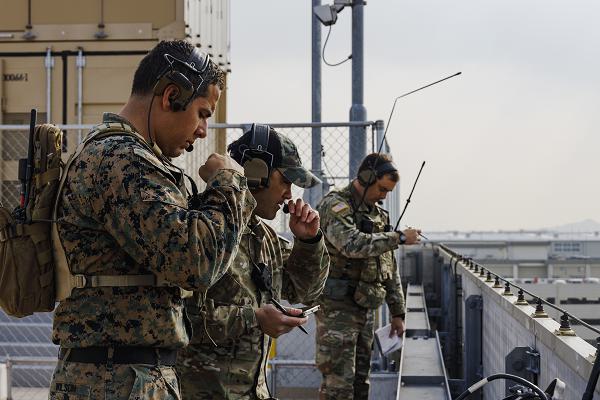 U.S. Marine Staff Sgt. Joshua Wilson, front, a joint terminal attack controller instructor with 5th Air Naval Gunfire Liaison Company (ANGLICO), III Marine Expeditionary Force Information Group, and U.S. Army Special Forces operators with 1st Special Forces Group (Airborne), conduct simulated close air support (CAS) using handheld Link 16 radios at Marine Corps Air Station (MCAS) Iwakuni, Japan, Feb. 15, 2022. The training focused on the joint force’s ability to integrate and refine tactics of CAS, which requires detailed planning and careful coordination between pilots and forces on the ground. (U.S. Marine Corps Photo by Lance Cpl. Brienna Tuck)