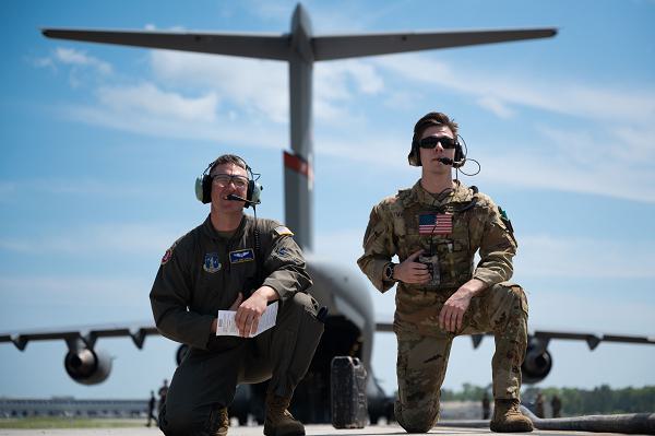 Master Sgt. Greg Barham, 167th Airlift Wing instructor loadmaster, and Staff Sgt. Christian Magliocca, 15th Airlift Squadron instructor loadmaster, await refueling operations to complete during the Forward Area Refueling Point Rodeo at Joint Base Charleston, S.C., April 2, 2024. By conducting FAPR training, C-17 Globemaster III crews develop a greater agility and ability to quickly respond and provide global power projection under the cover of darkness in austere environments. (U.S. Air Force photo by Staff Sgt. Spencer Slocum) 
