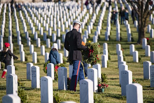 Volunteers participate in the 31st Wreaths Across America Day at Arlington National Cemetery, Arlington, Va., Dec. 17, 2022. On this day, nearly 30,000 volunteers placed 257,000 wreaths at every gravesite, columbarium court column, and niche wall column at Arlington National Cemetery. (U.S. Army photo by Elizabeth Fraser / Arlington National Cemetery / released)