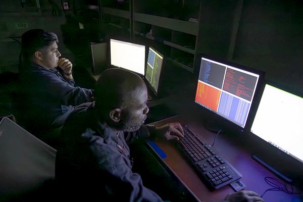240515-N-WV584-1022 PACIFIC OCEAN (May 15, 2024) Cyber Warfare Technician 2nd Class Paul Mendez, from Lake Elsinore, Calif., left, and Cyber Warfare Technician 1st Class Romeo Mashaka, from Richmond, Va., conduct a training exercise aboard the Nimitz-class aircraft carrier USS Abraham Lincoln (CVN 72). Abraham Lincoln, flagship of Carrier Strike Group Three, is underway conducting integrated exercises to bolster strike group readiness and capability in the U.S. 3rd Fleet area of operations. (U.S. Navy photo by Mass Communication Specialist Seaman Joey Sitter)