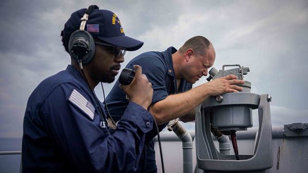 Chief Quartermaster Matthew Frey, right, from Louisville, Kentucky, looks through a telescopic alidade as Quartermaster 3rd Class James Handy, left, from Miami, Florida, operates a sound powered headset during a sea and anchor evolution aboard the amphibious dock landing ship USS Harpers Ferry (LSD 49) as the ship makes port at Puerto Princesa, Philippines, May 24, 2024. Harpers Ferry and embarked elements of the 15th MEU are conducting routine operations in the U.S. 7th Fleet area of operations. U.S. 7th Fleet is the U.S. Navy’s largest forward-deployed numbered fleet, and routinely interacts and operates with allies and partners in preserving a free and open Indo-Pacific region. (U.S. Navy photo by Mass Communication Specialist 2nd Class Sang Kim)
