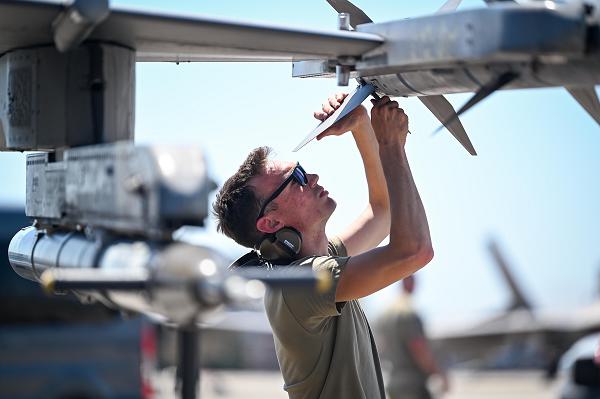 Senior Airman Brett Egan, 79th Fighter Generation Squadron weapons load crew member, ensures the readiness of training munitions before takeoff during exercise Checkered Flag 24-2 and the Weapons System Evaluation Program at Tyndall Air Force Base, Fla., May 15, 2024. Weapons maintenance Airmen increased operations to support both CF 24-2 and WSEP simultaneously, quickly swapping between live and training munitions to ensure uninterrupted exercise operations for 79th Fighter Squadron pilots. (U.S. Air Force photo by Senior Airman Steven Cardo) 
