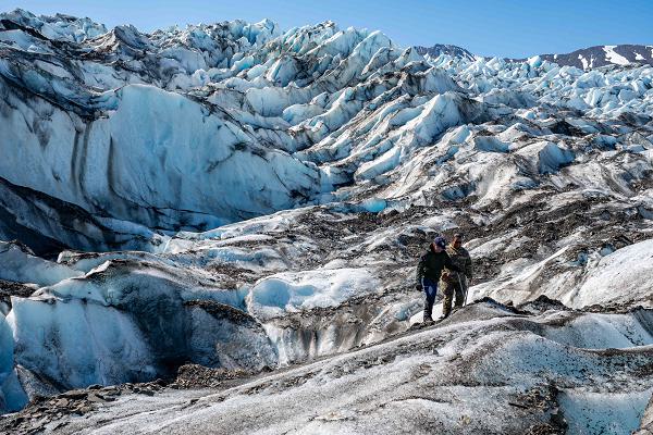 Capt. Travis Lockwood, Operation Colony Glacier deputy ground forces commander, shows Lt. Col. Crystal A. Glaster, Air Force Mortuary Affairs Operations deputy commander, how a recovery team searches through debris at Colony Glacier, Alaska, June 14, 2024. Operation Colony Glacier is an effort to recover the remains of 52 service members and wreckage from a C-124 Globemaster II that crashed in November 1952. (U.S. Air Force photo by Tech. Sgt. Don Hudson) 