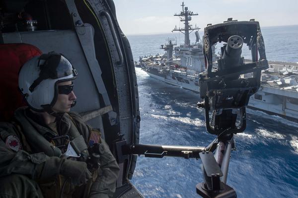 Naval Aircrewman (Helicopter) 3rd Class Michael Case, from Mountain Home, Arkansas, mans an M3 .50-caliber machine gun inside an MH-60S Sea Hawk helicopter  assigned to the “Black Knights” of Helicopter Sea Combat Squadron (HSC) 4 while underway with the Nimitz-class aircraft carrier USS Carl Vinson (CVN 70) in the U.S. 3rd Fleet area of operations. As an integral part of U.S. Pacific Fleet, U.S. 3rd Fleet operates naval forces in the Indo-Pacific in addition to providing realistic and relevant training necessary to flawlessly execute our Navy’s timeless roles of sea control and power projection. U.S. 3rd Fleet works in close coordination with other numbered fleets to provide commanders with capable, ready forces to deploy forward and win in day-to-day competition, in crisis, and in conflict. (U.S. Navy photo by Mass Communication Specialist Seaman Kenneth Ostas)                                                     