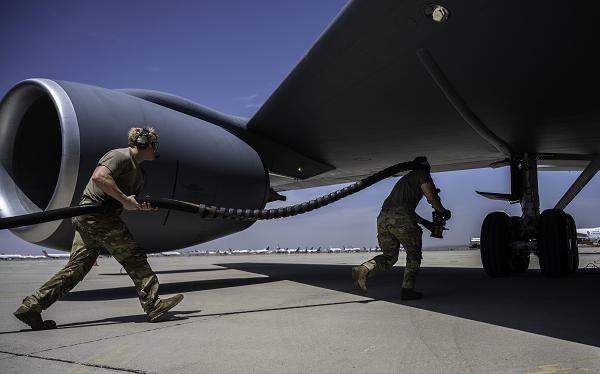 U.S. Air Force Staff Sgt. Craig Oliver, left, 6th Aircraft Maintenance Squadron flying crew chief, and Staff Sgt. Jacob Ebberts, 52nd Logistics Readiness Squadron petroleum, oils, and lubricants technician, hot pit refuel a KC-135 Stratotanker during Exercise Bamboo Eagle 24-3 in Victorville, Calif., Aug. 7, 2024. Hot pit refueling involves supplying an aircraft with fuel while its engines are running to expedite the turnaround time needed to relaunch the aircraft. Bamboo Eagle focuses on mission readiness by delivering cross-functional and lethal combat capabilities with speed and agility. (U.S. Air Force photo by Tech. Sgt. Alexander Cook) 