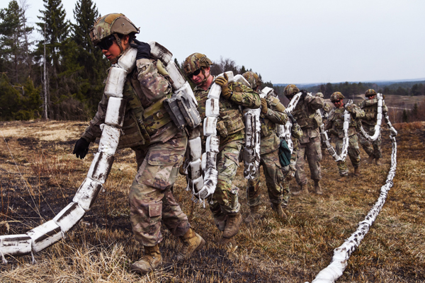 In this photo by Markus Rauchenberger, Army Lieutenant Colonel Alexander Samms, commander of the 10th Brigade Engineer Battalion, 1st Armored Brigade Combat Team, 3rd Infantry Division leads his soldiers in recovering an M69A2 Line Charge during a training exercise at the 7th Army Command’s Grafenwoehr Training Area, Germany. Unlike their Revolutionary War comrades, these soldiers have sophisticated explosive devices like these to slow an enemy’s advance.