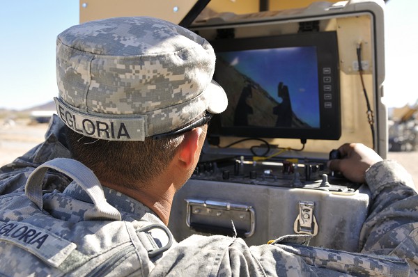 In this U.S. Army photo, Specialist Dennis Egloria, a combat engineer from the 18th Engineering Company, 2nd Battalion, 3rd Infantry Regiment drives a robot through a simulated street searching for explosives at the National Training Center, California.