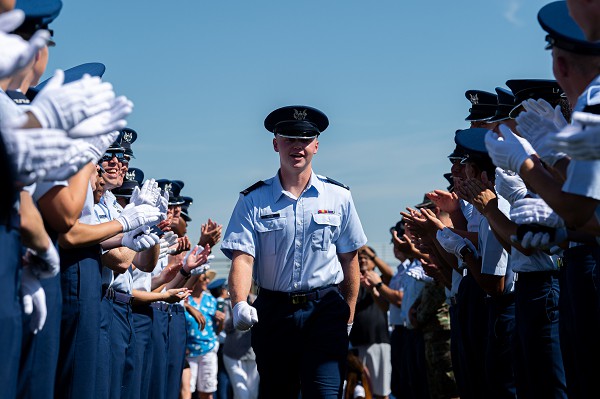 Colorado Springs, CO. (August 8, 2022): In this photo by Trevor Cokley, U.S. Air Force Academy cadets form a congratulatory line during Acceptance Day ceremonies at Stillman Field.  Here cadets receive their fourth-class shoulder boards recognizing their completion of basic training and signifying their acceptance into the Cadet Wing or freshman class at the Air Force Academy.  This is only the first step in a four-year college journey followed by at least five years of active-duty service as an officer in America’s armed forces.