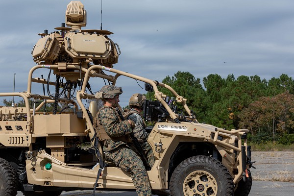 Cherry Point, NC. (December 5, 2022): In this photo by Sergeant Servante Coba, U.S. Marine Corps PFC Clayton Hilemon and Sergeant Alexander Locconielsen, low altitude defense gunners with the 2nd Low Altitude Defense Battalion, transmit an electronic signal to an incoming drone aircraft using the Light Marine Air Defense Integrated System (L-MADIS). The L-MADIS is an electronic attack system that targets enemy drones using signals to destroy or negate their threats to fellow Marines. The 2nd LAAD is part of the 2nd Marine Aircraft Wing which is the aviation element of the 2nd Marine Expeditionary Force.
